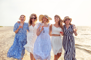 Group of women on the beach drinking wine